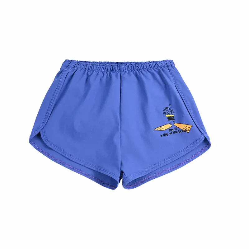 A Day At The Beach Swim Trunks by Bobo Choses